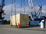 Loading process of a large wooden package on a ship